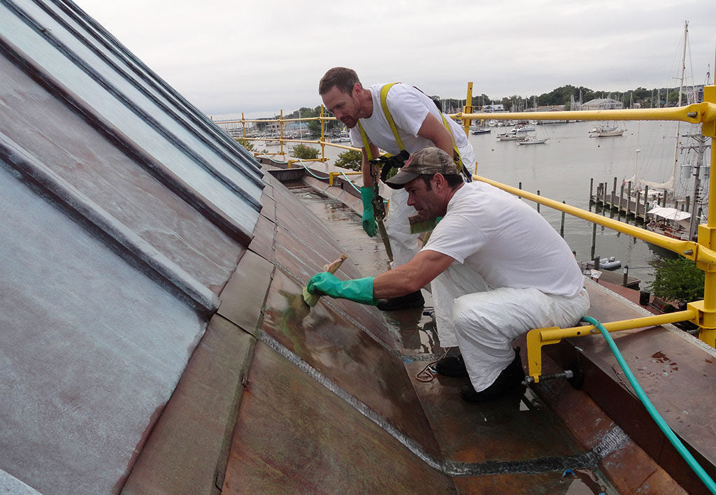 Applicators treating a copper roof at the United States Naval Academy