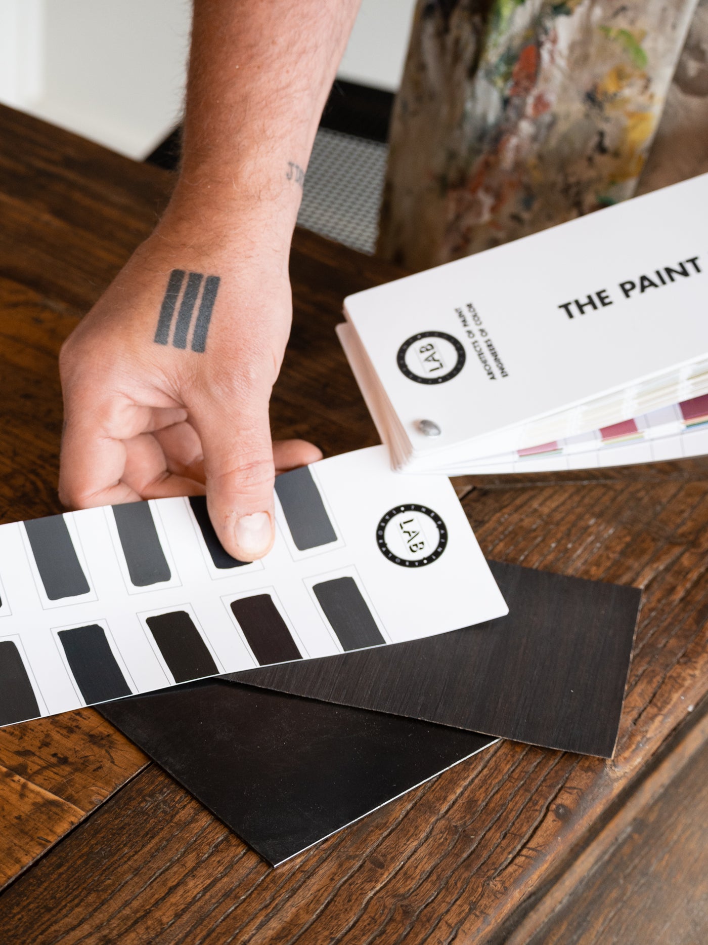 Hand-painted Paint Laboratory color samples being reviewed